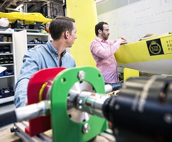 SMaRC team members in the lab working with a robot.