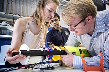 SMaRC team members in the lab working with a robot.